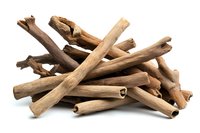 Aromatic cinnamon sticks and bark pieces isolated on white background, natural spice ingredient for cooking, baking and flavoring beverages.