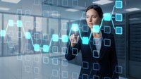 Professional businesswoman interacting with futuristic holographic interface displaying data analytics and digital technology in modern office environment.