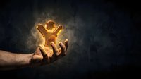 Male hand holding glowing golden trophy cup with radiant light effect against dark textured background, symbolizing success, achievement, and victory for business and sports concepts.