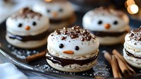 Festive snowman macarons with chocolate filling, decorated with candy features and cocoa powder dusting, arranged with cinnamon sticks on dark surface with bokeh lights.