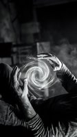 Hands creating magical swirling light spiral energy in monochrome artistic composition for mystical and supernatural design projects.