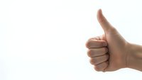 Hand showing thumbs up gesture on white background for positive feedback and approval concepts.