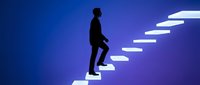 Silhouette of male professional climbing ascending staircase steps against blue gradient background, representing career growth, success, and business advancement for corporate training materials.
