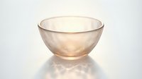 Elegant translucent glass bowl with soft golden hue casting delicate light reflections on white background, isolated for design use.