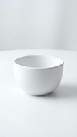 Empty white ceramic bowl with rounded sides on neutral background, suitable for product mockups, kitchenware catalogs, and tableware design presentations.