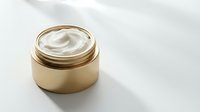 Luxury gold cosmetic jar with rich cream texture inside, isolated on white background for skincare, beauty product packaging, and wellness design applications.