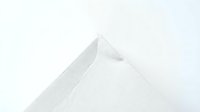 Minimalist white geometric paper pyramid with clean shadows on light background for modern design projects and architectural concepts.