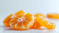 Fresh peeled mandarin orange segments on white background, showcasing juicy citrus fruit texture and vibrant color for food photography.