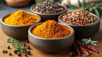Aromatic spices in rustic bowls featuring vibrant turmeric powder, mixed peppercorns and dried herbs with scattered chili peppers and bay leaves on dark surface.