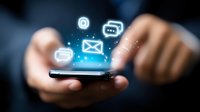 Glowing social media and messaging icons float above smartphone screen with hands holding device in dark setting, illustrating digital communication concept.