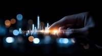 Digital graph with glowing chart lines touched by human hand against dark cityscape background with bokeh lights, representing financial technology and data analysis.