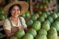 Smiling Asian female vendor in straw hat selling fresh green melons at local market, representing authentic farm-to-table commerce.