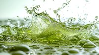 Dynamic splash of green-tinted water creating wave formation with droplets and ripples against blurred background, captured in high-speed macro photography.