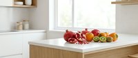 Fresh colorful bell peppers arranged on modern kitchen island countertop in bright contemporary home interior with natural lighting and minimalist design.