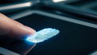 Finger touching glowing digital fingerprint on dark screen for biometric security authentication and identity verification access control technology.