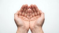 Open cupped hands gesture on white background showing palms up in receiving or offering position for charity, prayer, giving concepts.