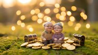 Elderly couple figurines sitting together surrounded by golden coins with warm bokeh lights creating romantic atmosphere for retirement planning concepts.