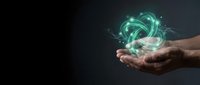 Hands holding glowing green energy sphere with swirling light effects on dark background for technology and innovation concepts.