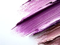 Metallic pink and rose gold smear texture on white background shows cosmetic product swatch with shimmering pearl effect. Makeup artistry and beauty concept.