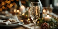 Elegant champagne flute with golden bubbles against festive bokeh background, set on holiday table with decorations and candlelight.