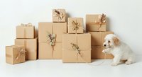Adorable white and tan puppy sitting among kraft paper gift boxes tied with natural twine and dried flowers on white background for holiday shopping.