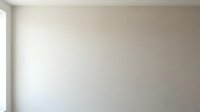 Blank beige wall with soft natural light and subtle shadow, suitable for mockups, presentations, and design overlays.