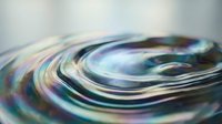 Abstract iridescent liquid swirl with rainbow reflections creating dynamic flowing motion patterns for modern digital art and creative design projects.