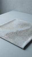 Gray linen fabric textile material on white surface with soft natural lighting for interior design and home decor projects.