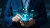 Businessman holding smartphone with glowing rocket hologram and digital interface elements representing startup launch and business growth technology.