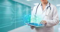 Doctor using digital tablet with holographic medical interface in modern hospital for telemedicine and healthcare technology applications.