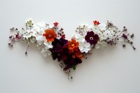 Delicate floral arrangement featuring orange, burgundy and white flowers with small crystal-like branches creating elegant V-shaped composition on light background.