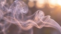 Abstract purple and pink smoke swirls flowing gracefully against warm golden bokeh background creating ethereal atmospheric effect for relaxation concepts.
