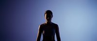 Silhouette of a young man with dark skin tone standing against a blue gradient background, suitable for corporate, wellness, and motivational content.