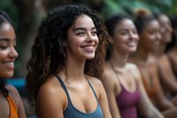 Happy diverse women in sportswear smiling during outdoor fitness class or yoga session. Group of multiethnic females enjoying healthy lifestyle and exercise.