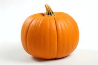 Fresh orange pumpkin isolated on white background, showing natural texture and stem detail. Suitable for seasonal marketing, food packaging, and harvest themes.