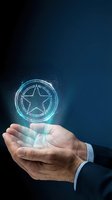 Close-up of businessman's hand holding glowing star symbol with particle effects against dark blue background. Represents success, achievement, quality rating, excellence, and digital innovation for business concepts.