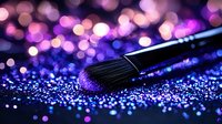 Makeup brush with purple glitter sparkles on dark background, soft bokeh lights creating magical atmosphere for beauty and cosmetics photography.