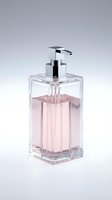 Modern clear glass soap dispenser with chrome pump containing pink liquid soap on neutral background for bathroom decor and hygiene products.