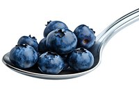 Fresh ripe blueberries on silver spoon isolated on white background, macro shot showing texture and natural blue color of organic berries.