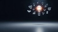 Glowing light bulb with business innovation icons on dark background representing creative ideas, strategy planning, and entrepreneurial success concepts.