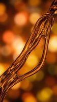 Golden liquid honey or syrup flowing in smooth stream with warm bokeh background for culinary and food photography projects.