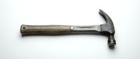 Worn claw hammer with rubber grip isolated on white background, a classic hand tool for construction, carpentry, and home repair projects.