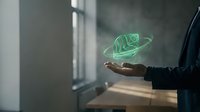 Cropped view of person holding glowing green leaf neon sign in hand against window with natural light, representing eco-friendly technology and sustainability concepts for environmental campaigns.