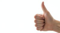 Hand showing thumbs up gesture on white background expressing approval and positive feedback for business success concepts.
