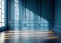 Empty classic room interior with blue walls, decorative molding panels, wooden floor, and dramatic window light casting shadows, suitable for luxury design projects.