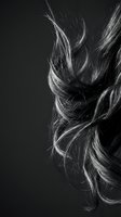 Dynamic flowing hair strands in motion against dark background showcasing natural texture and movement in monochrome artistic style.