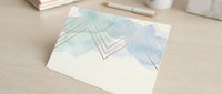 Modern abstract watercolor business card mockup with geometric line art design on wooden desk surface for branding and corporate identity projects.
