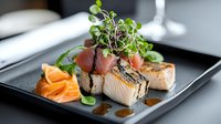Grilled salmon fillet topped with microgreens and prosciutto, served on black slate plate with carrot garnish and sauce drizzle, fine dining presentation.