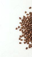 Roasted coffee beans scattered on white textured background with copy space, suitable for cafe menus, beverage packaging, and coffee shop marketing materials.