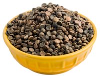 Dark chocolate chips in bright yellow ceramic bowl against white background, isolated food ingredient for baking and cooking.